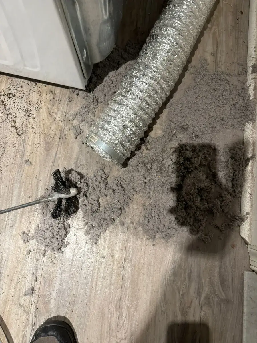 Dryer vent cleaning job photo — lint removed from a clogged vent line